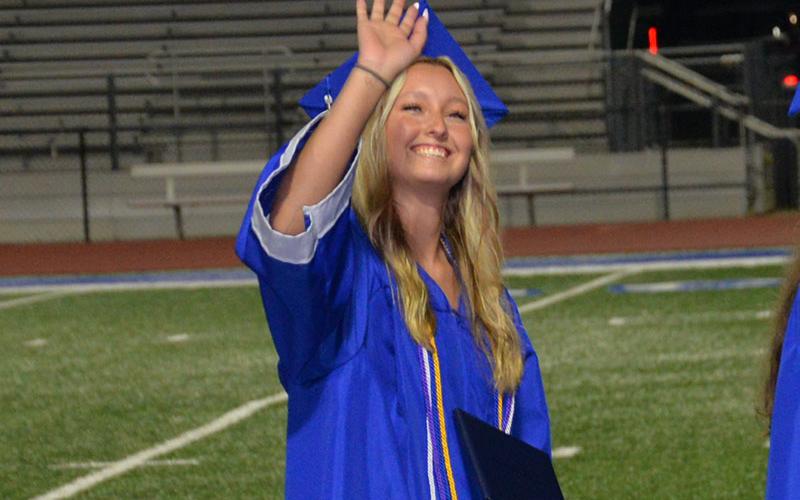 Fannin graduate waving to family and friends.