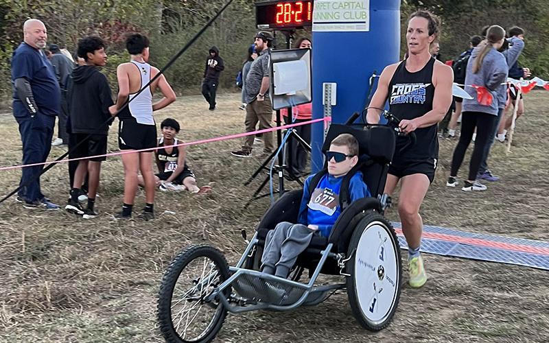 Brady Smith crosses the finish line in one of his many races this year with his mother, Ashley Herendon-Weeks, close behind.
