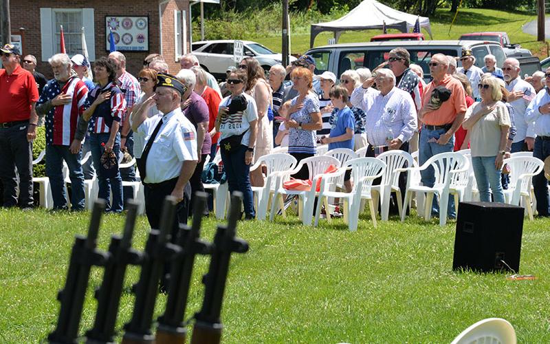 Veteran Kevin O’Quinn leads members of the Memorial Day crowd in saluting during the service Monday, May 27, at Veterans Memorial Park in Blue Ridge.