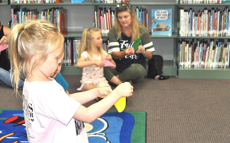 Charlotte Bailey and her little sister, Adeline Bailey learned how to make a firefly out of a piece of paper.