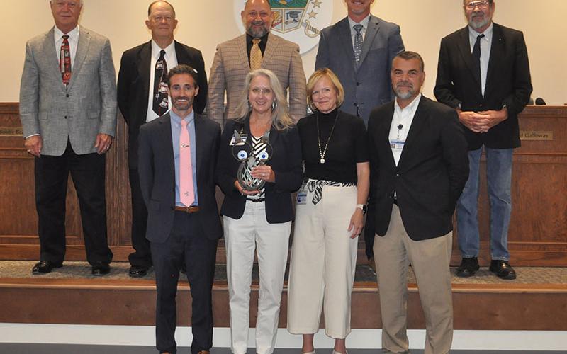 The Fannin County School System honored Martha Williams for her hours of hard work and dedication to the Community Eligibility Provision program. She is shown with front row, from left, Chief Academic Officer Dr. Lucas Roof, Williams, School Superintendent Shannon Dillard, and  Chief Operation Officer and Senior Executive Darren Danner; and back ro, board members, Terry Bramlett, Bobby Bearden, Mike Cole, Chad Galloway, Lewis DeWeese.