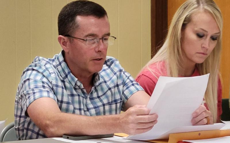 Polk County District 3 Commissioner Keith Barker reads a resolution presented by District 3 Commissioner Samantha Trantham, right, that would have expressed the commission’s disapproval for a Boys &amp; Girls Club to be located on the Copperhill Industries Superfund sSite.