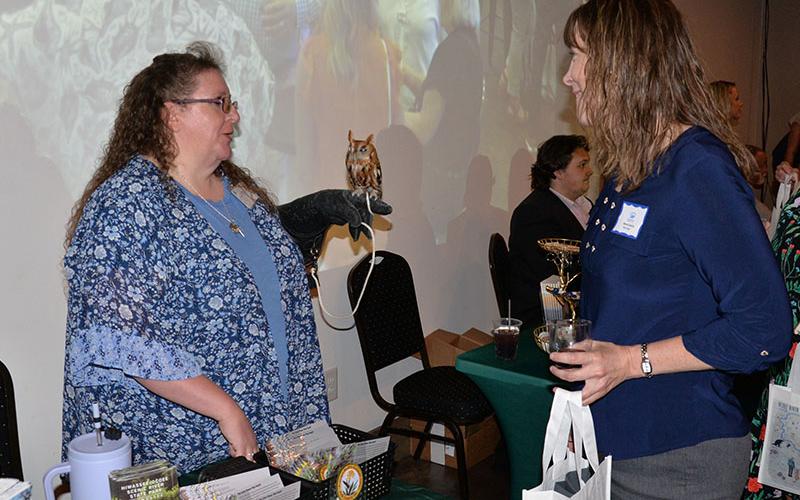 RIGHT: Manda Gwatney, right, visits with an exhibit featuring a blind owl during the kickoff event for TVA’s Ocoee Whitewater Rafting &amp; Fly Fishing Experience.