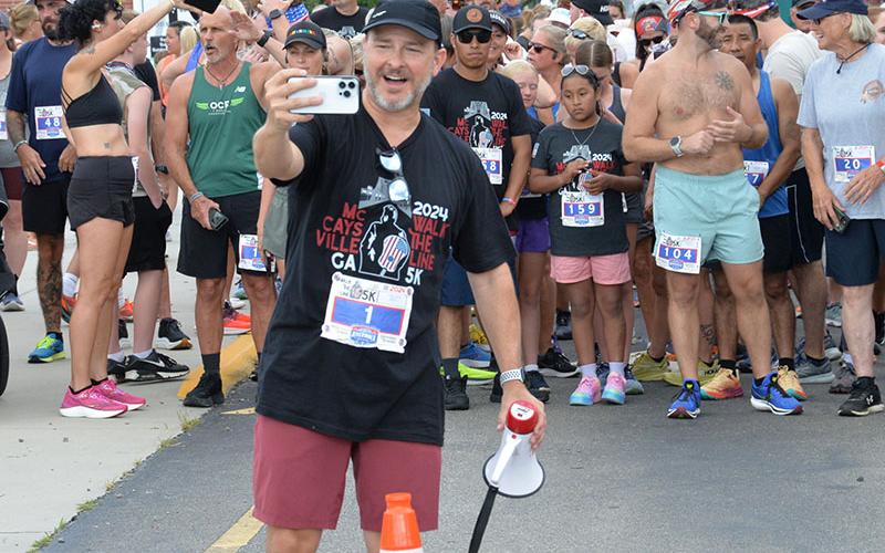 Matt Cole, above, did some pre-race photography as runners prepared for the Walk the Line 5K Saturday.