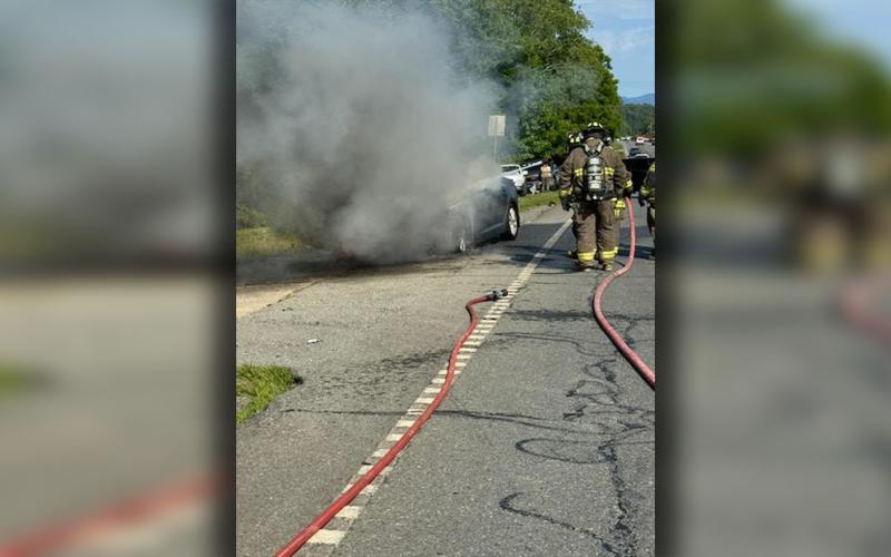 This car fire had traffic backed up when a vehicle pulled in front of a responding fire fighter.