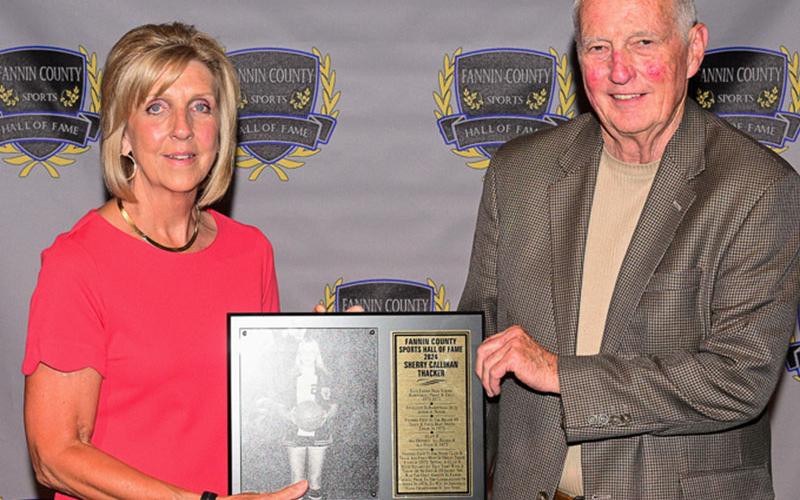 Inductee Sherry Callihan Thacker accepted her plaque from her high school coach, Buzz Quintrell.