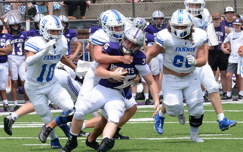 Noah Burnette (#88) wraps up a Gilmer ball carrier as Luke Holsonback (#11), Jacob Dye (#60), and Isaac Watkins move in for the assist.