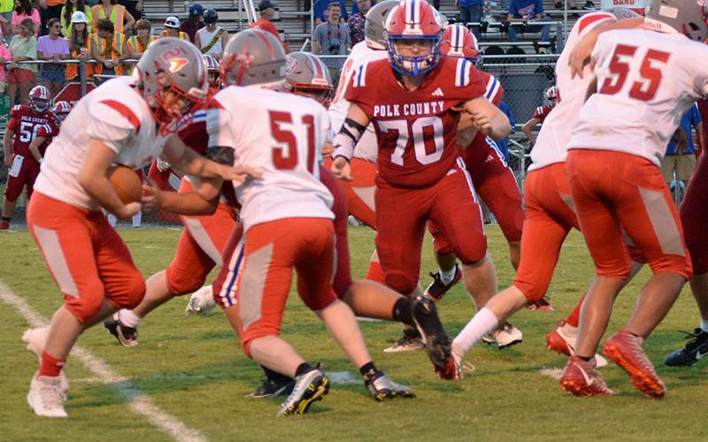 Copper Basin’s Luke Elrod takes a handoff as Seth Picklesimer sets a block in the Cougars game against Polk County.