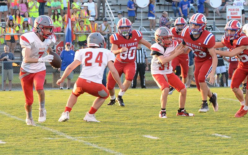 Copper Basin’s Nathan Spencer (7) looks to get around the Polk County defense behind the blocking of Luke Elrod (24) and Dawson Pittman (31).