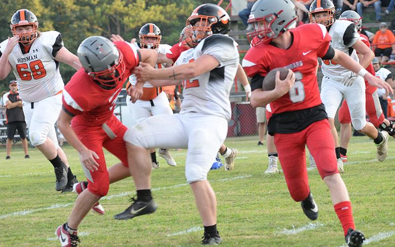 Copper Basin’s Drew Crowder (6) makes his way around the Rosman defense Friday night in the Cougars’ second scrimmage of the season.