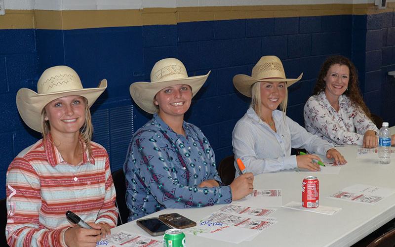 After showing off their barrel racing skills, these cowgirls took time to sign autographs for the many Special Olympic athletes and their friends at the rodeo preview Friday.