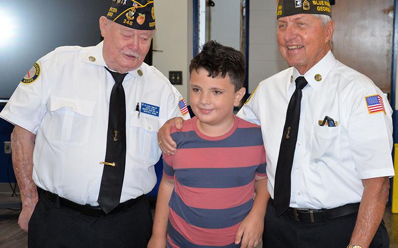 Camden Shook was welcomed to the flag etiquette class by veteran Ronnie Rabun.