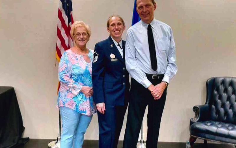 Master Sergeant Laura Ash, middle, is pictured with her parents Billie Ash and Dellon Ash II at her Air Force retirement ceremony.