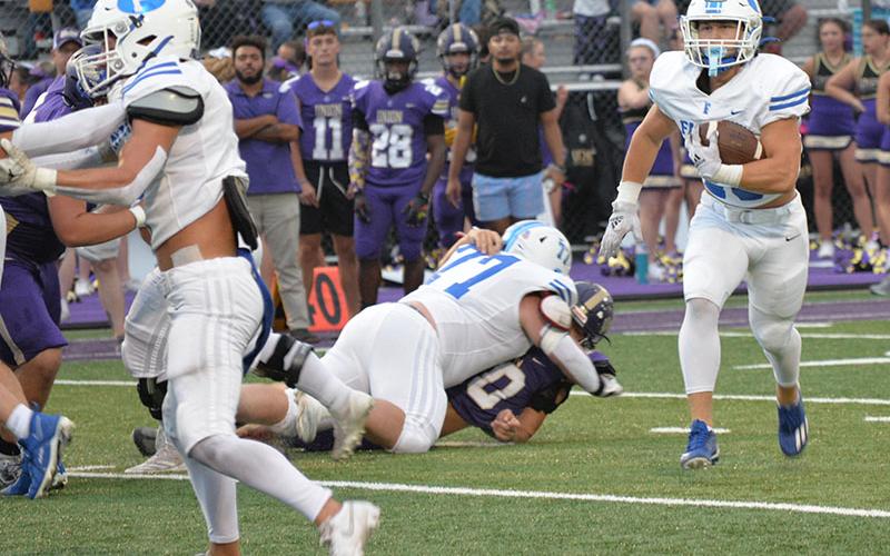 Braden Taylor sets the lead block after Jacob Green (77) makes a hole in the offensvie line for Carson Callihan to gain some of his 61 yards against the Union County Panthers Friday night in Blairsville.