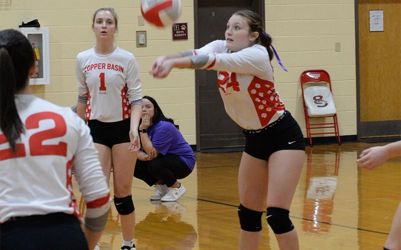 Riley Akens (#24) sets a return for the Copper Basin Lady Cougars volleyball team in recent action. The Lady Cougars improved their season record to 4-3 with the win.