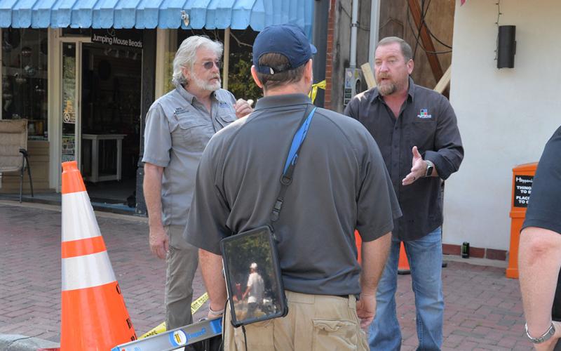 Blue Ridge City Councilman Jack Taylor, right, makes a point with Fannin County Building Inspector Keith Nicholson, left, and engineer Nathan Heinlein over the hazardous condition of the building at 781 East Main Street.