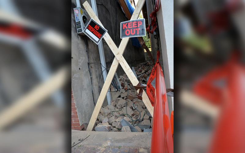 Debris from a partially collapsed wall at 781 East Main Street filled the alley between it and the building next door.