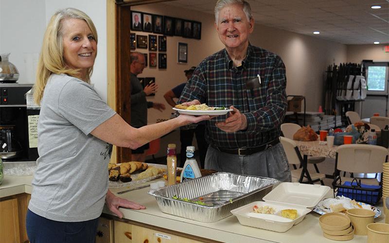Volunteer Denise Nelson is shown serving lunch to Ralph Garner as he attends the free weekly lunch at Eema’s Kitchen Friday, September 13.