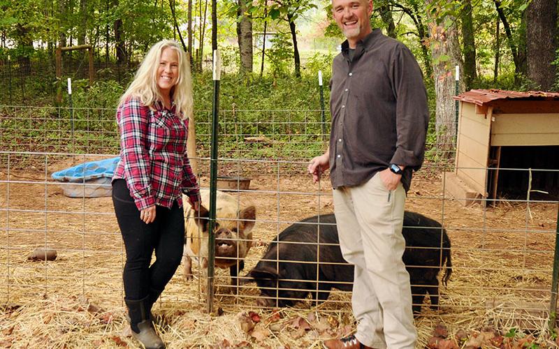 Beth and Dr. Kyle Raque are the minds behind the Healing Farm Foundation. They are shown with Pugsley and Pigley.