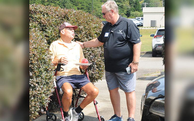 North Georgia Veterans Assistance Foundation Founder and Board Member Ken Brenneman, right, talks with Robert Foster after the ribbon cutting for the foundation.