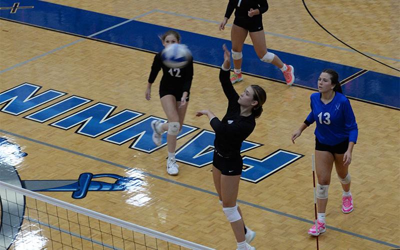 Kaylie Davenport (#1) lines up a return for the Lady Rebels. Also shown are Keslie Key (#12) and Maggie Ledford (#7).