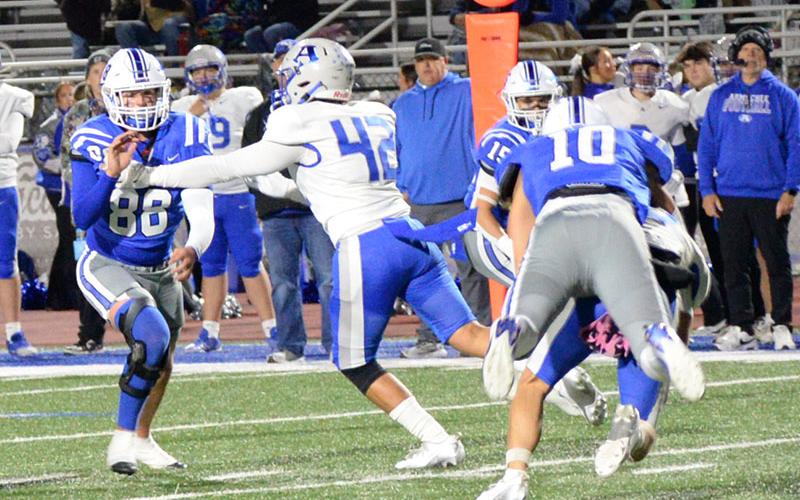Luke Holsonback (10) catches the Armuchee quarterback from behind as Scott Waldrep (15) cuts off his running room and Noah Burnettmakes his way around an Indian blocker Friday night on the Fannin County football field.