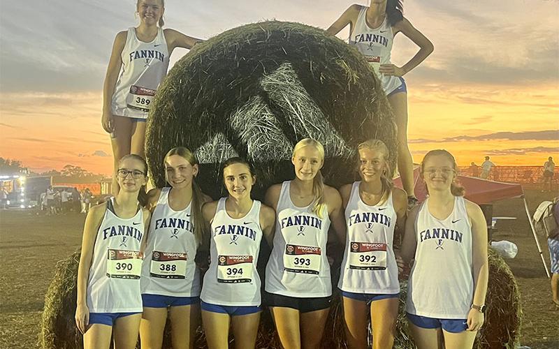The Fannin County girls cross country team, from left, standing,  Sydney Ford, Lila Borum, Karli Sams, Kensley Pickelsimer, Lindsey Holloway and Claire Saxon; and, top, Annaleigh Cheatham and Lana Hicks ran in the nighttime Championship Race at Wingfoot.