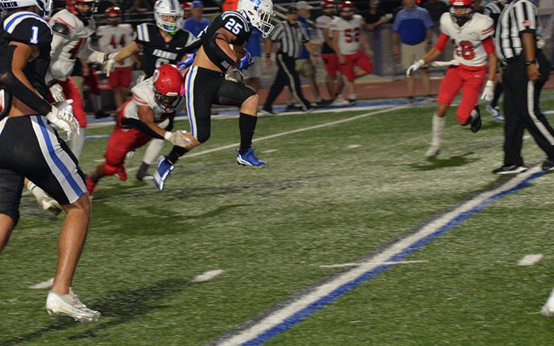 Carson Callihan (#25) has powered through opposing defenses all season for the Fannin County Rebels, as he does here in action earlier this year. Friday night the Rebel senior gained 301 yards in a game that pitted the last two undefeated teams in 7-A Division 1 against each other.