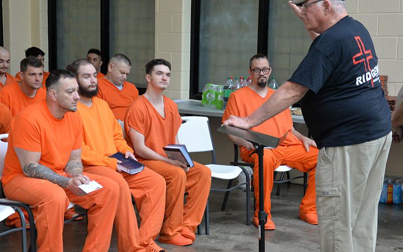 Bill Rush, standing, talks to inmates at the Fannin County Jail prior to the Breaking Man graduation ceremony Sunday, September 29. Rush told inmates he didn’t have to be there, he could be home in his recliner, but God had called him to the ministry sponsored by The Ridge Community Church. Listening to Rush are, from left, front row, Samuel Butts, Jordan Cole and Peyton Russo.