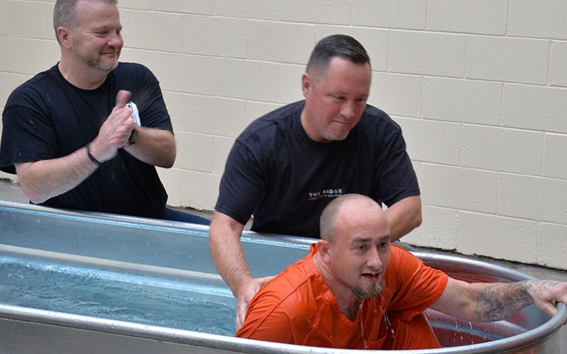 Daniel Morrow emerges after being baptized by Rev. Chan Mitchell at the Fannin County Jail. Mitchell conducted the ‘outward evidence of the inner change’ for several inmates.