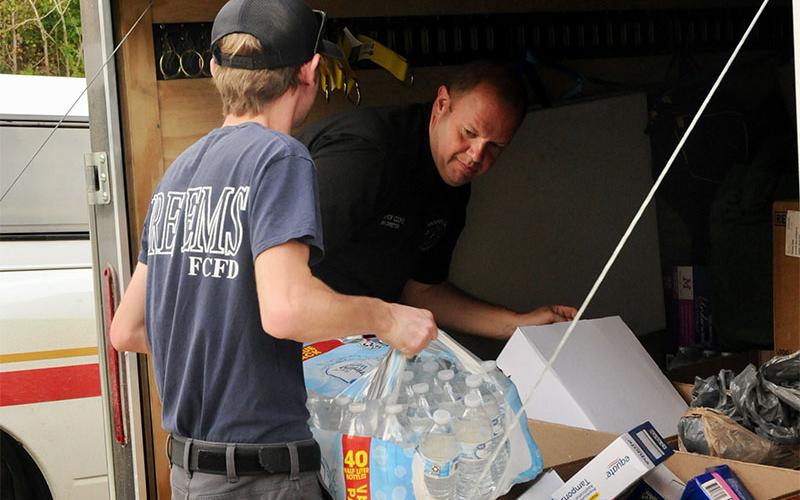 Fannin County Emergency Management Agency Director Patrick Cooke and Firefighter Trent Lowery load items before making another trip into North Carolina Tuesday, October 1. Several trailer loads were taken by Fannin County volunteers on several different days last week.