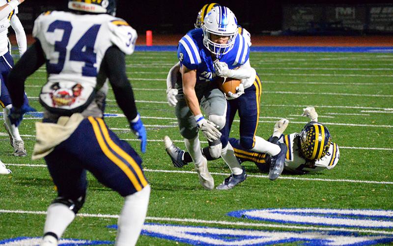 Fannin County’s Braden Taylor works to escape the grasp of a Jeff Davis defender Friday night.