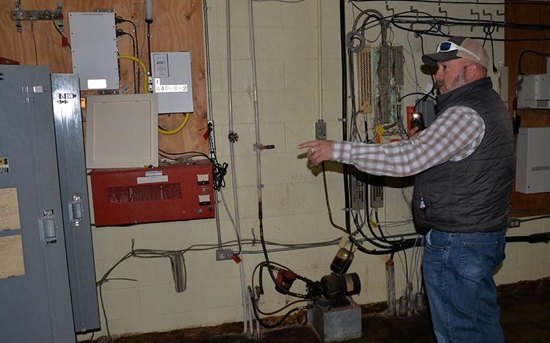 Polk County Executive Robby Hatcher describes some of the repairs that will be done to the wiring at the Copper Basin Community Center. Shown is part of the space occupied by the Copper Basin Fire Department.