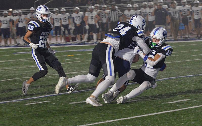 Fannin County’s Cannon Holloway (12) and Cooper Hillard (24) bring down a Gordon Lee ballcarrier in action Friday night. By the time the second quarter was underway, fog on the field at Fannin County High School was so thick spectators on the home side of the stadium couldn’t see what was happening on much of the field.