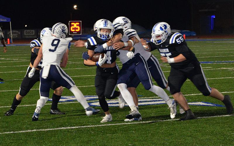 Braden Taylor (4) fights for yardage against Gordon Lee with the help of Baylor Twiggs (55).