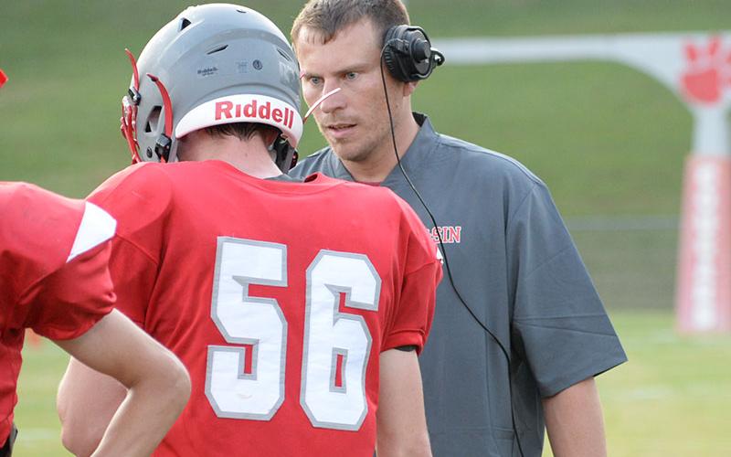 Copper Basin Cougar head coach Brett Graves explains a play to Mason Anderson (56) in a game early this season. The Cougars finished the season shutting out two of their last three opponents.