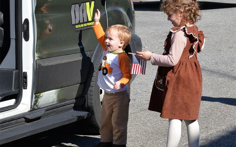 These youngsters took part in the Veterans Day Parade by welcoming members of the Disabled American Veterans.