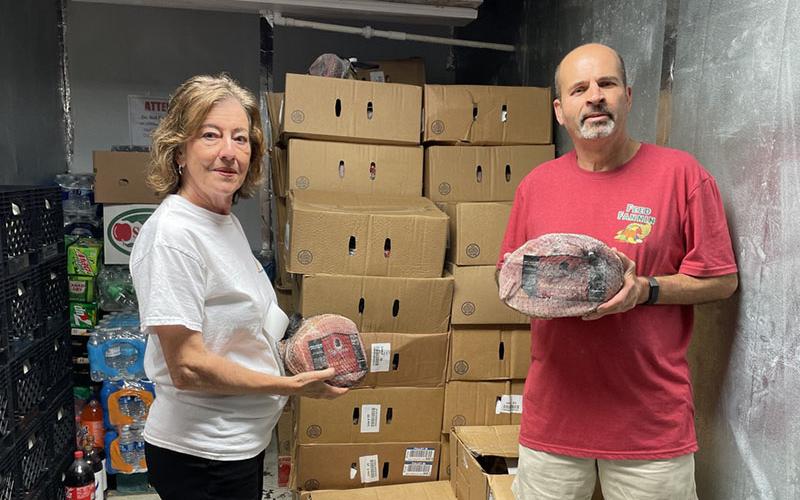 Feed Fannin Vice Chair of Farm and Facilities and Agriculture Education Kathy Beck is pictured with a Feed Fannin volunteer as they received their first shipment of hams and turkeys for the Holiday Meals Campaign.