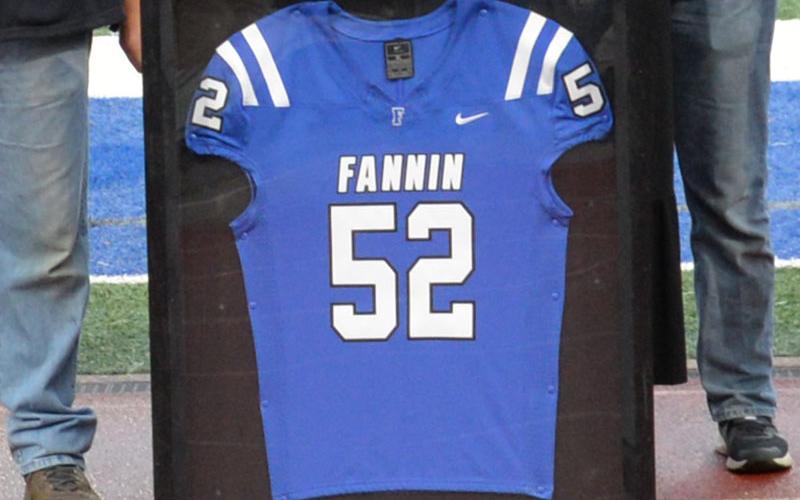 John Holsonback’s framed football jersey was presented to his family during senior night.