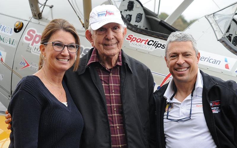 Army Veteran Vernon Chesser, middle, smiles with daughter Amy Beavers and Pilot Jeff Klosky after taking his “Dream Flight” on a World War II-era Stearman biplane Friday, November 1.