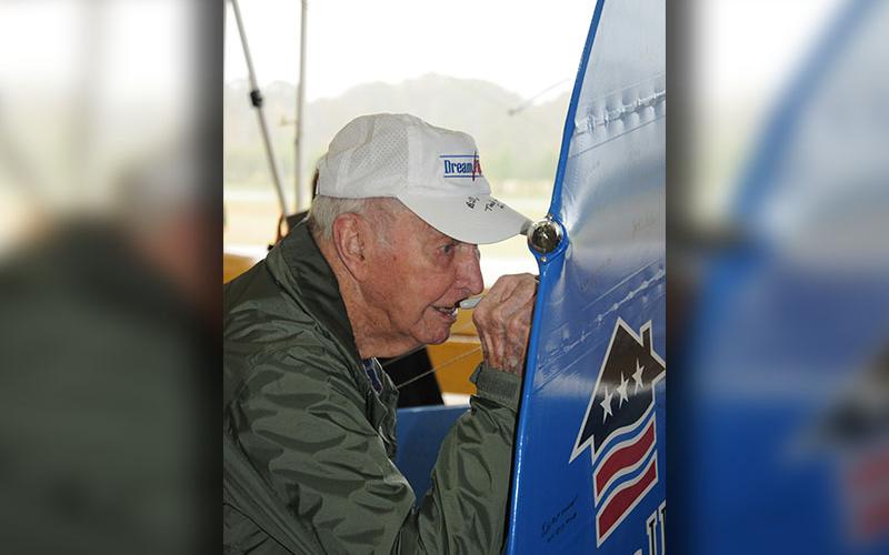 World War II Navy veteran Bill Langford signs the rudder of the plane following his “Dream Flight.” This is a privilege for WWII veterans alone.