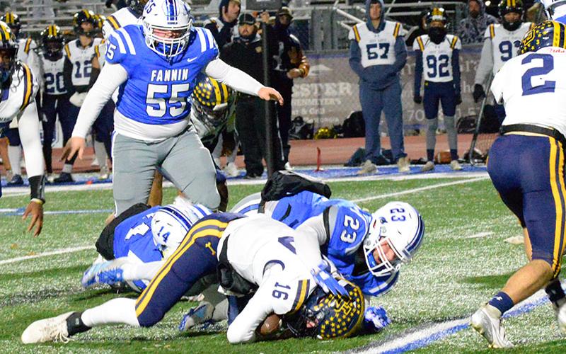 CJ Reece (23) and Cooper Born (14) combined to plant the Jeff Davis quarterback on this play Friday night with Baylor Twiggs (55) helping add to Fannin’s defensive pressure.