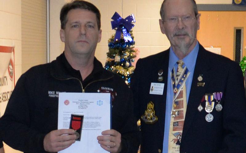 Firefighter Mike Miller received a special award from Sid Turner of the Sons of the American Revolution.