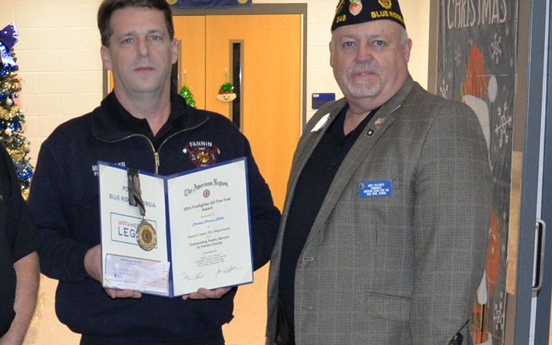 American Legion Commander Jim Callender, right, of Post 248 in Blue Ridge presented firefighter Mike Miller an award for his actions.