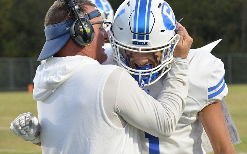 In his typical fashion, Fannin County Rebel Head Coach Chad Cheatham congratulates Tucker Dockerty for a job well done.