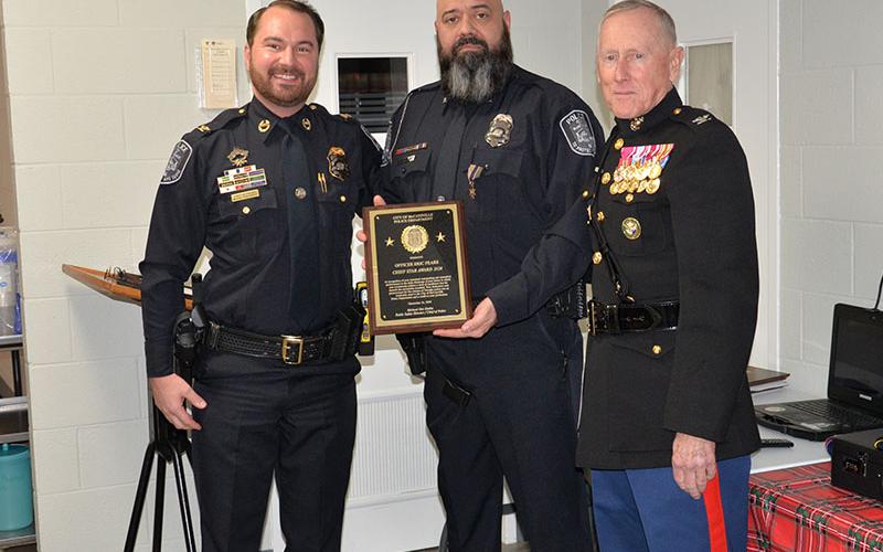 McCaysville Police Officer Eric Fears, center, was presented the Chief’s Star Award and a Life Saving Award at the department’s annual banquet. Taking part in the presentations were Police Chief Michael Earley and U.S. Marine Corps Colonel (Ret.) Mike Nunnally.