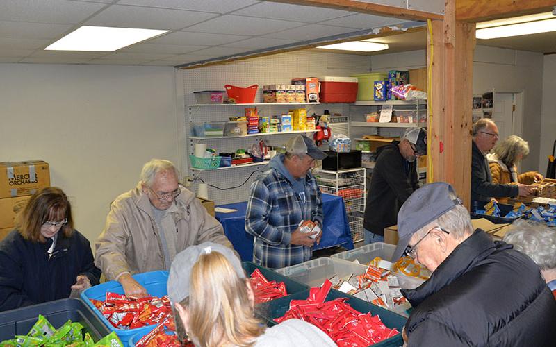 News Observer photo/Glenn Harbison These are only a few of the Snack in a Backpack volunteers who gathered last Wednesday, December 10, for the last packing day before schools dismiss for the holidays.