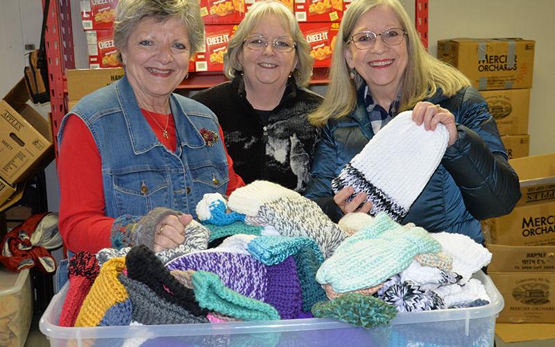 These three “Knitwits” from Faith Presbyterian Church delivered 529 handmade, knitted hats to Snack in a Backpack last week to be given to Fannin County School children. Kim King, Frances Thompson and Betty Benedict, from left, are part of the group that call themselves the Knitwits and gather regularly to make the hats.
