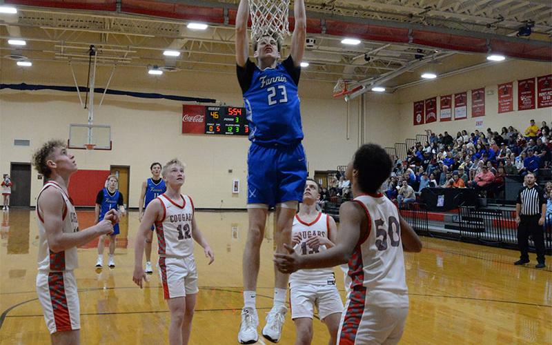 Kolton Kaylor slams in two points for Fannin County against Basin’s Cougars.