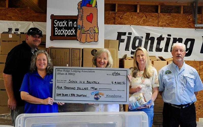 With funds raised from the 2024 Blues and BBQ event, committee members donated $4,000 to Snack in a Backpack Thursday, November 7. There for the check presentation is, from left, Paul Gribble, Dena Martin, Snack Executive Director Debby Beck, Heather Bradley and Greg Spencer.